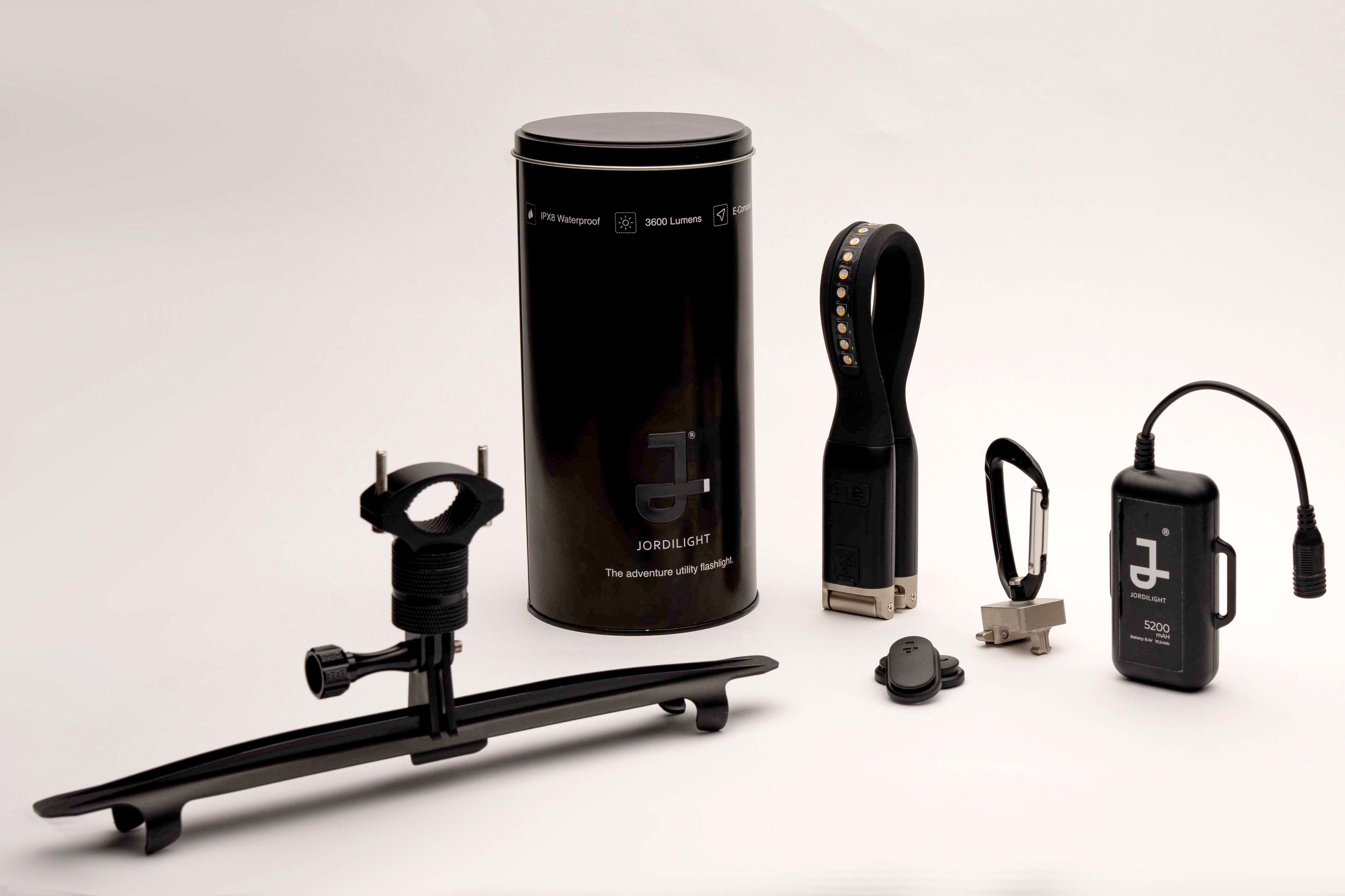 JordiLight Ultimate Kit displayed with all accessories, including portable charger, helmet attachment kit, handle bar attachment kit, and carabiner clip, designed for versatile outdoor use.